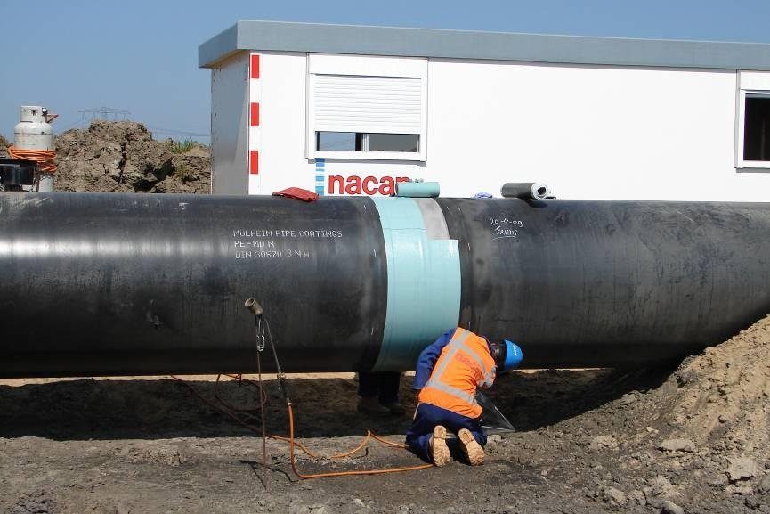 Buried pipeline field joint under construction