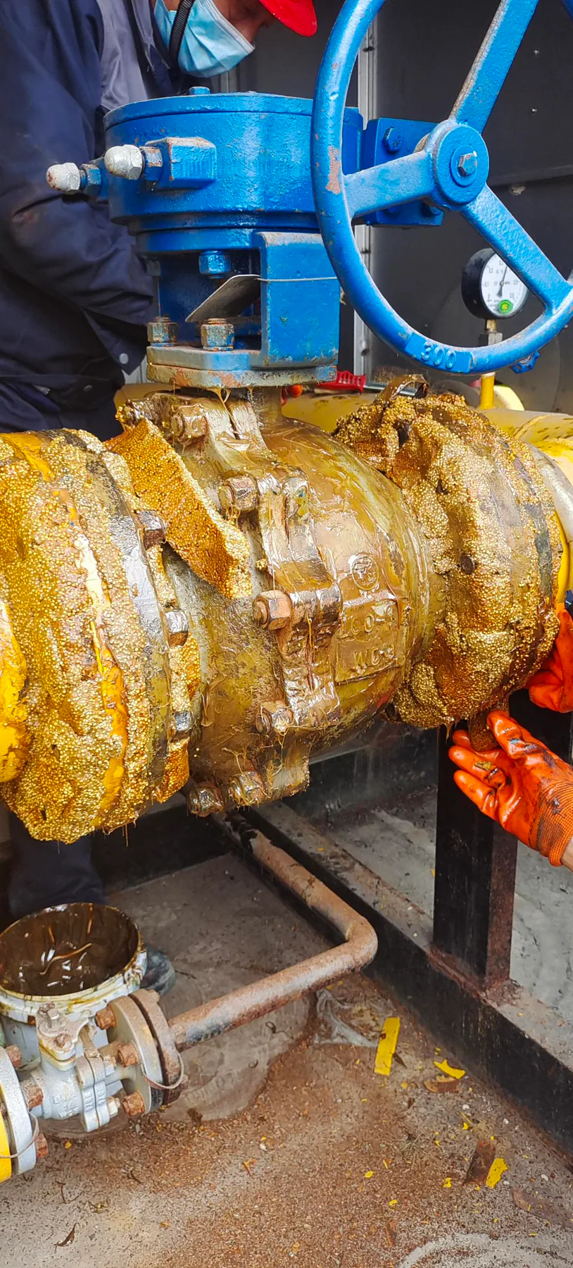 Petrolatum tape being wrapped around the Hangzhou valve and flange assembly.